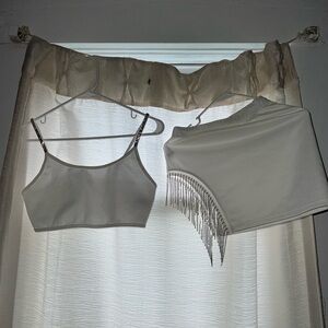 It is a white skirt and top set, size S